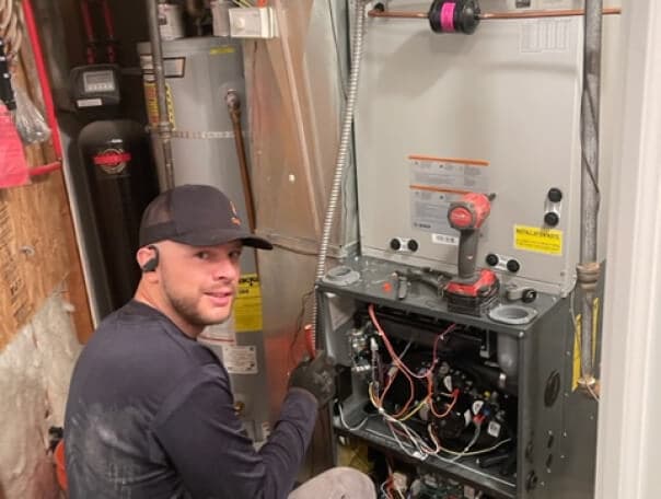 Technician repairing a residential heating system.