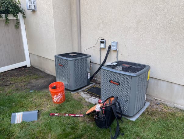 Air conditioning units repair with tools outdoors.
