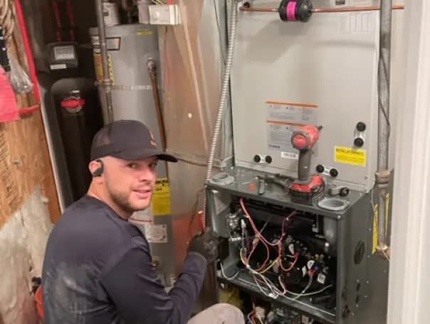 HVAC technician checking refrigerant levels on a condenser
