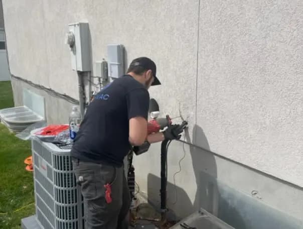 Technician inspecting a furnace burner assembly