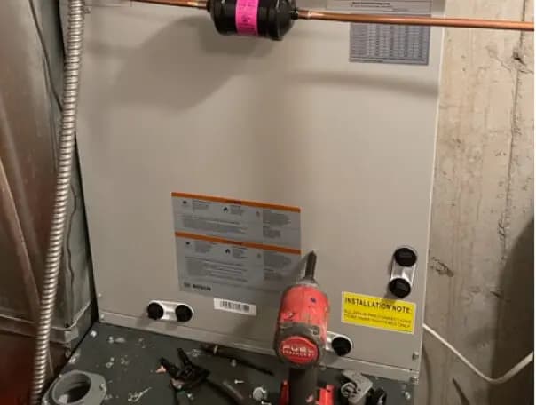 Technician cleaning an air conditioner condenser coil