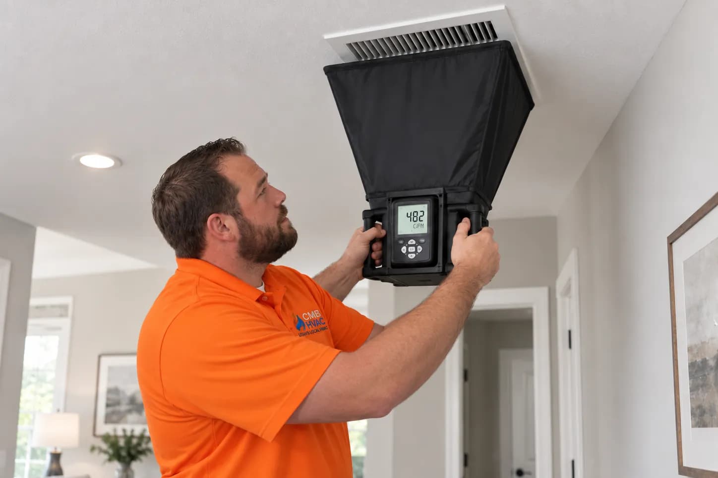 Illustration of a technician measuring airflow at a ceiling register