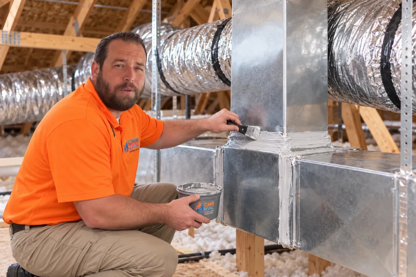 Illustration of a technician sealing duct joints with mastic in an attic