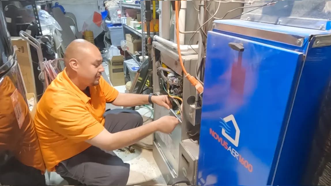 CMB HVAC technician walking toward a service van