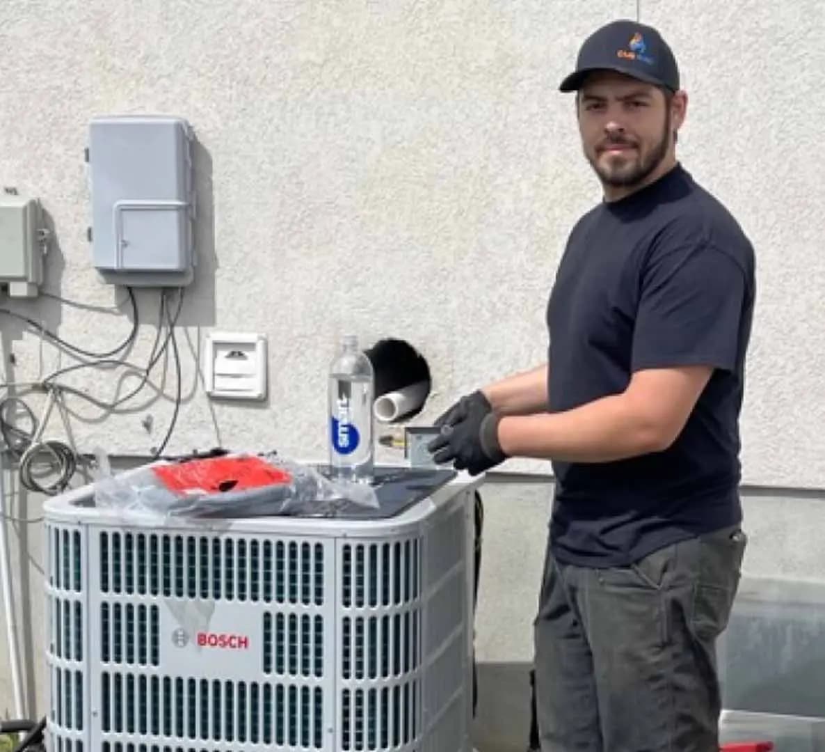 Technician installing a central air system outdoors