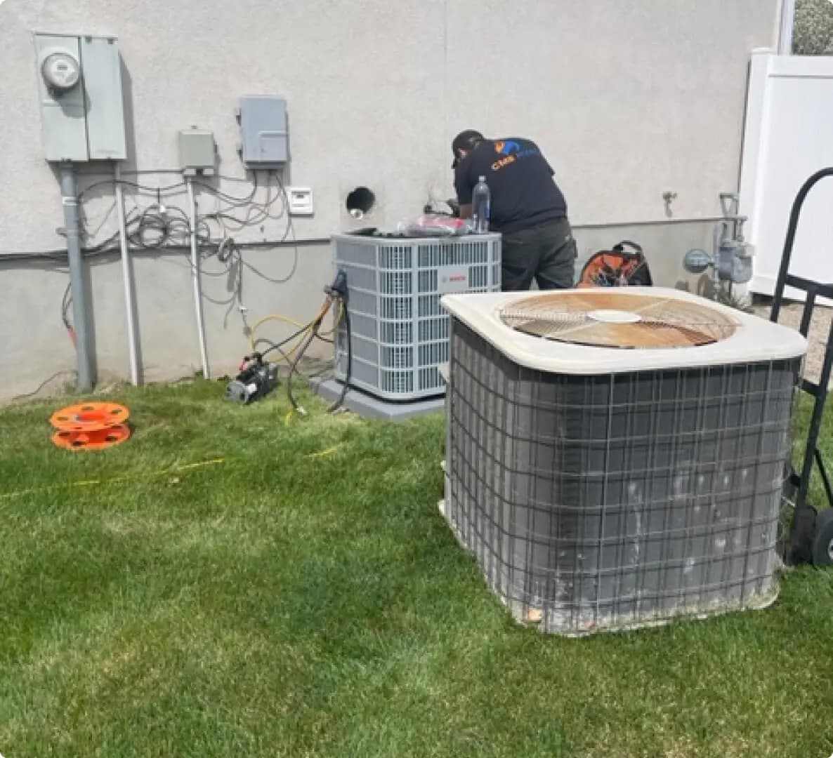 Technician servicing a wall-mounted heating unit