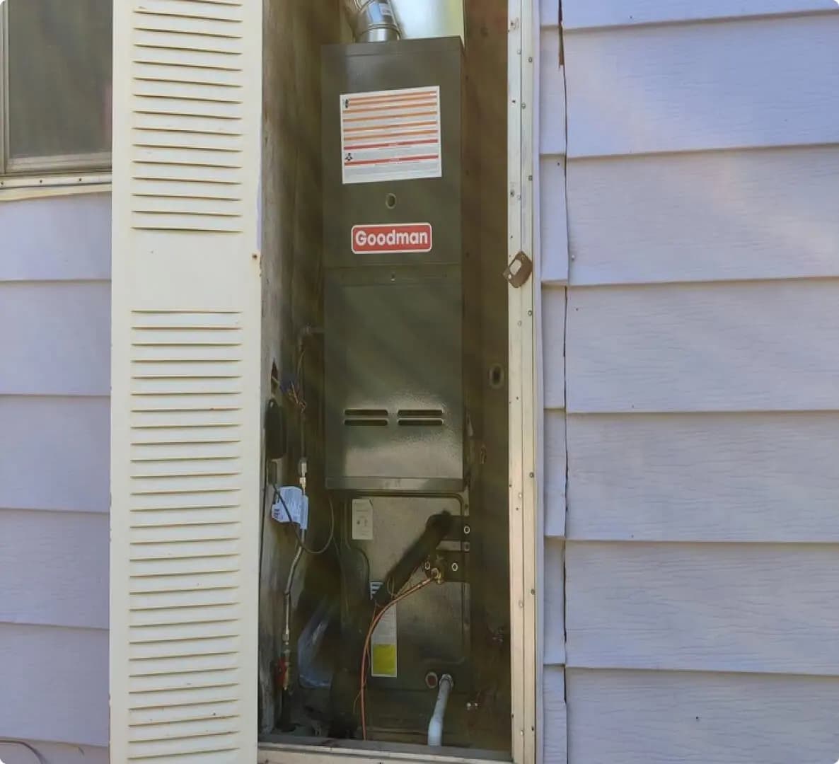 Open furnace closet showing a fresh equipment installation